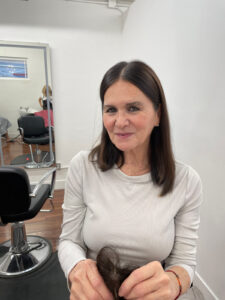 Woman wearing brown hair topper in Paula's Wig Boutique Toronto