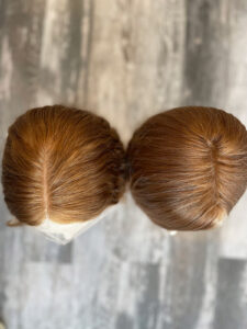 Overhead view of two European lace-top human hair wigs in our Miami stores