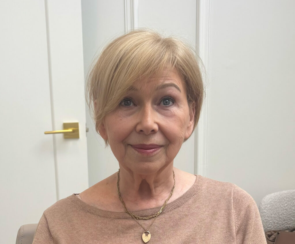 Woman wearing blonde European hair piece